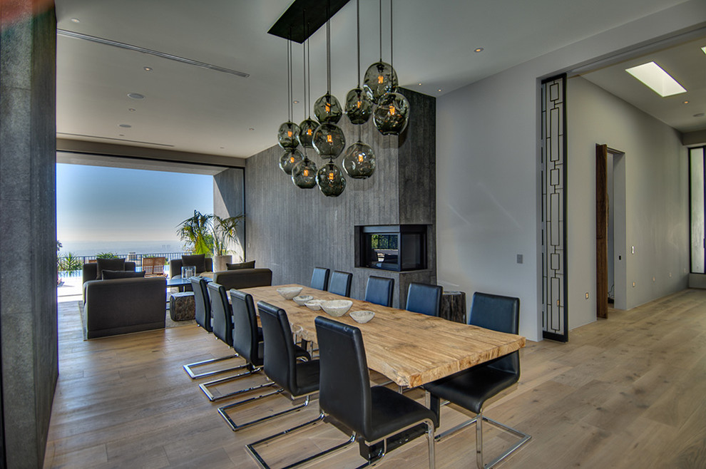 Minimalist dining room photo in Los Angeles with a standard fireplace