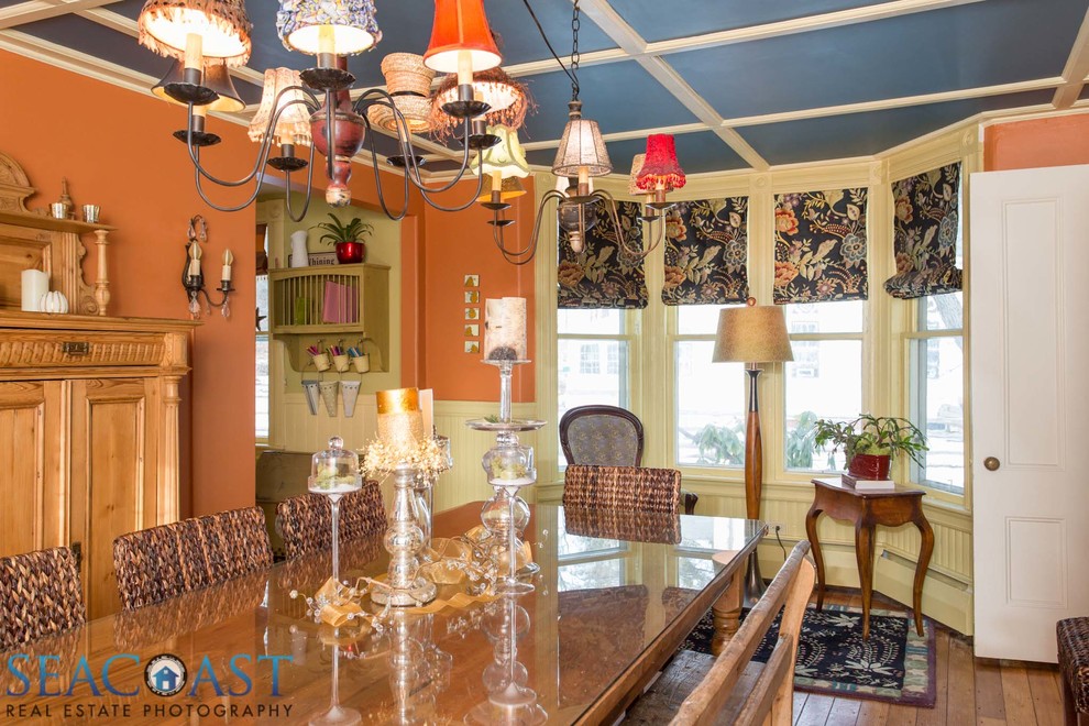 Inspiration for a medium sized rural enclosed dining room in Other with orange walls, medium hardwood flooring and feature lighting.