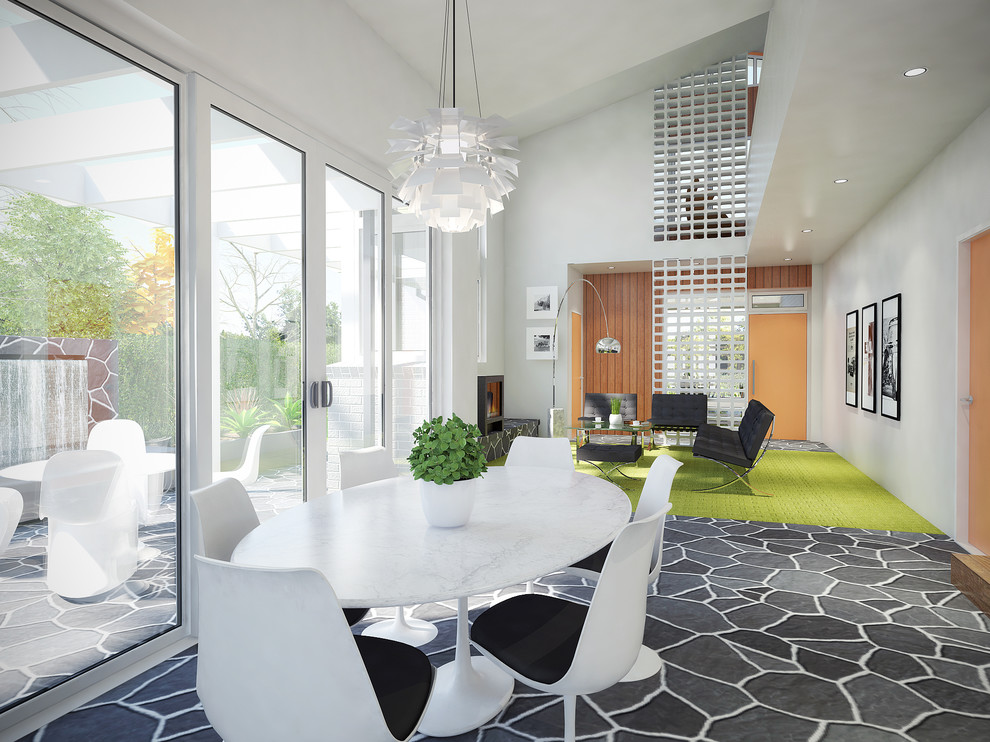 Immagine di una sala da pranzo aperta verso il soggiorno minimalista di medie dimensioni con pareti bianche e moquette