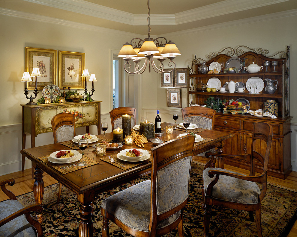 Photo of a traditional dining room in New York with beige walls, medium hardwood flooring and a dado rail.