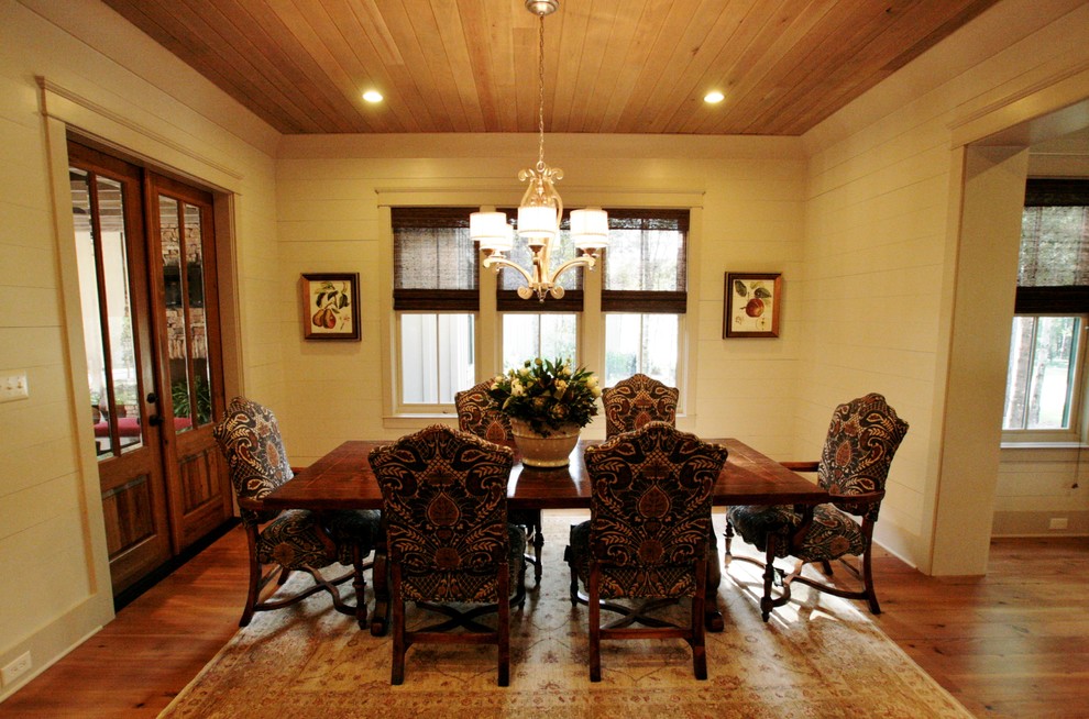 Example of an arts and crafts light wood floor dining room design in Other with beige walls