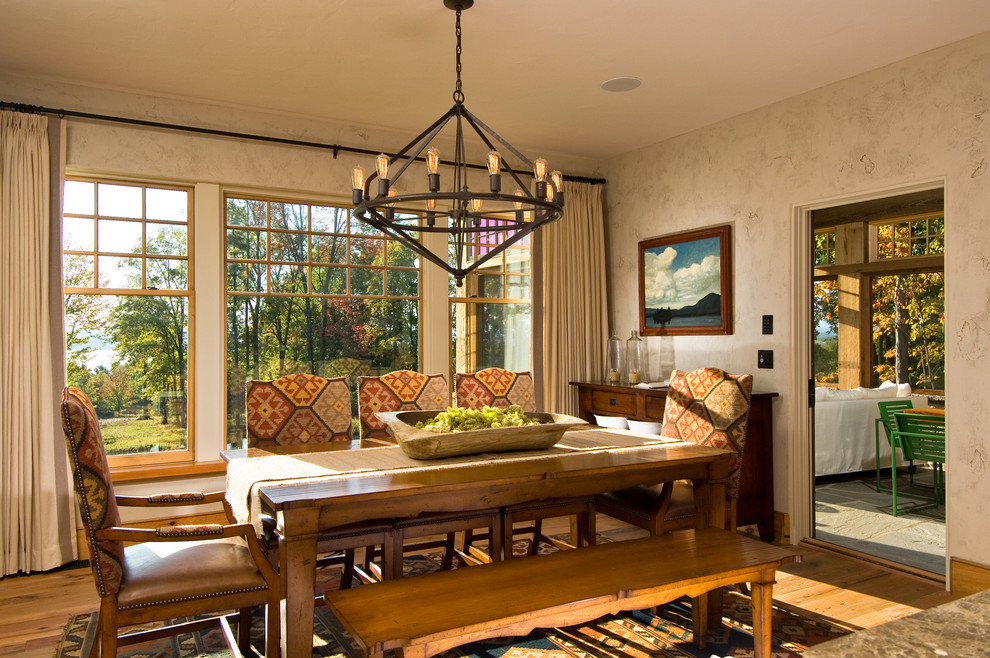 Example of a mountain style medium tone wood floor dining room design in New York with beige walls