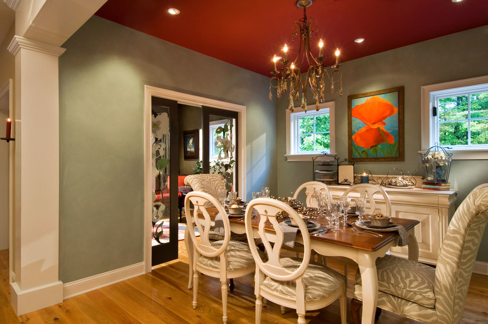 Cette image montre une salle à manger rustique avec un mur gris et un sol en bois brun.