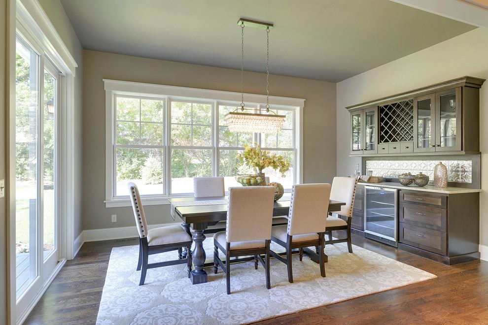Traditional dining room in Minneapolis with beige walls and dark hardwood flooring.