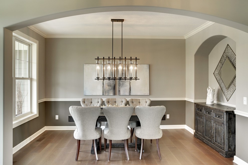 Design ideas for a large classic enclosed dining room in Minneapolis with grey walls and light hardwood flooring.