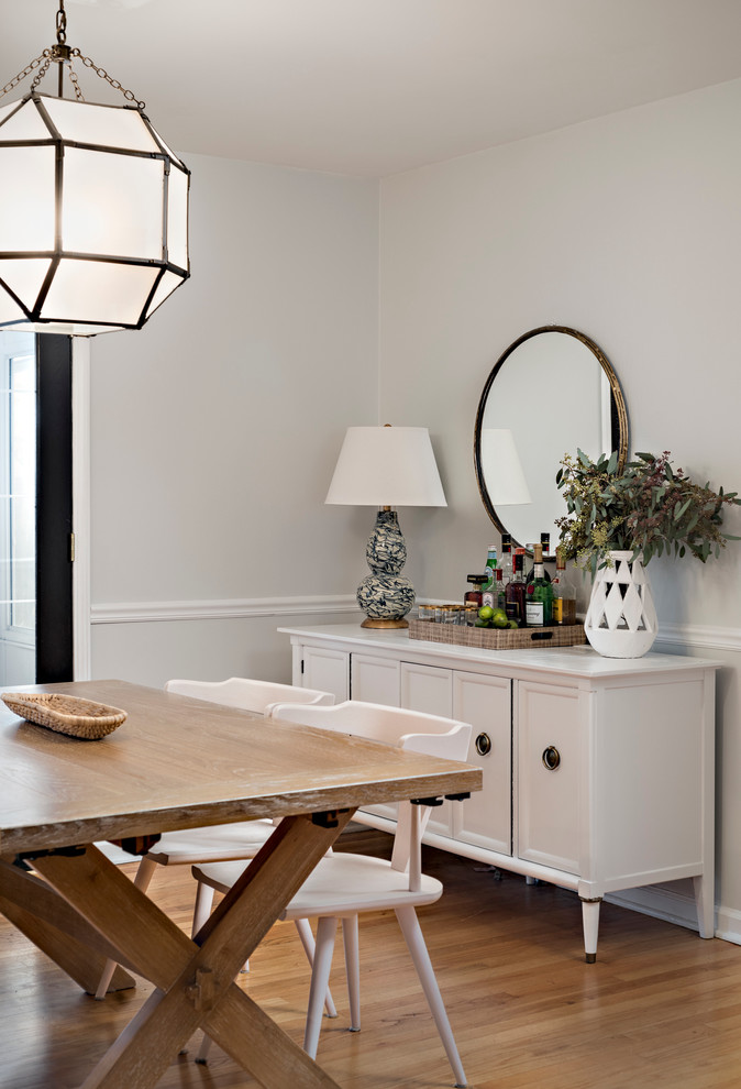 Photo of a classic dining room in Chicago with white walls and light hardwood flooring.