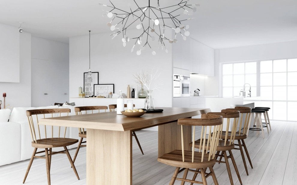 Diseño de comedor escandinavo abierto con paredes blancas, suelo de madera clara y suelo blanco