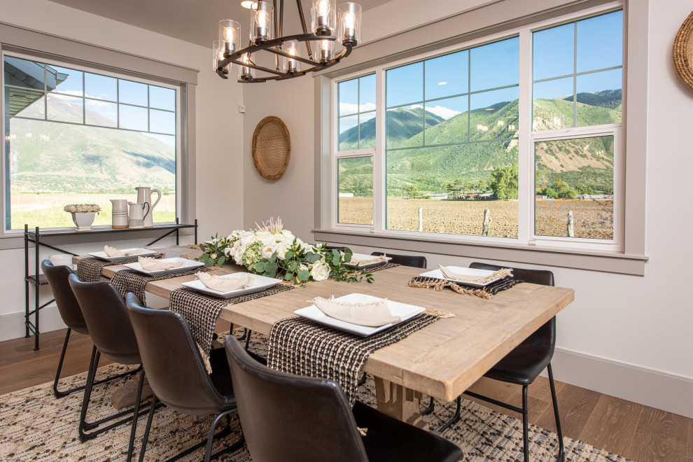 Design ideas for a large classic open plan dining room in Salt Lake City with beige walls, medium hardwood flooring, no fireplace and brown floors.