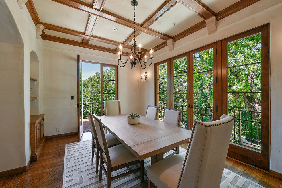 Example of a tuscan medium tone wood floor and brown floor dining room design in San Francisco with beige walls