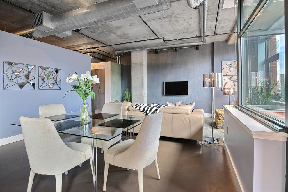 Example of a small urban concrete floor great room design in Denver with blue walls and no fireplace