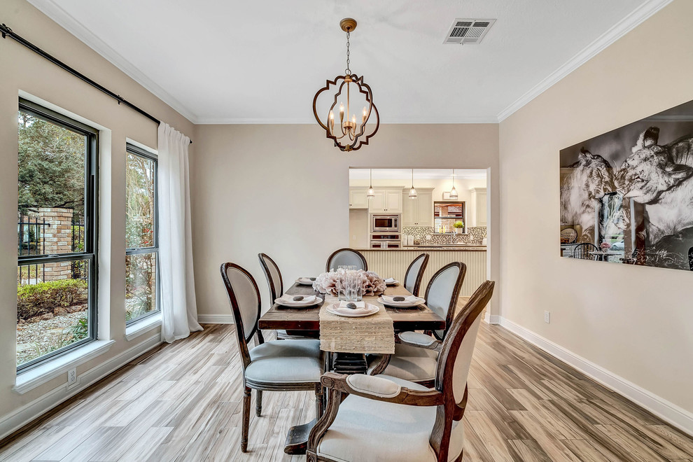 Photo of a medium sized contemporary enclosed dining room in Houston with beige walls, ceramic flooring, no fireplace and brown floors.