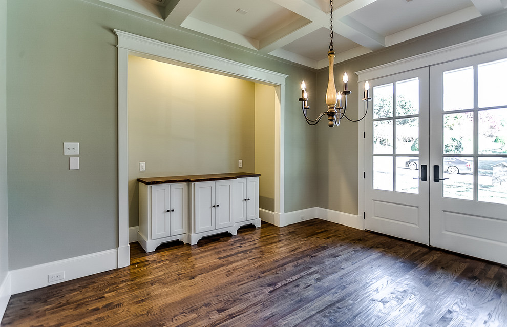 Inspiration for a mid-sized timeless medium tone wood floor enclosed dining room remodel in Dallas with beige walls and no fireplace
