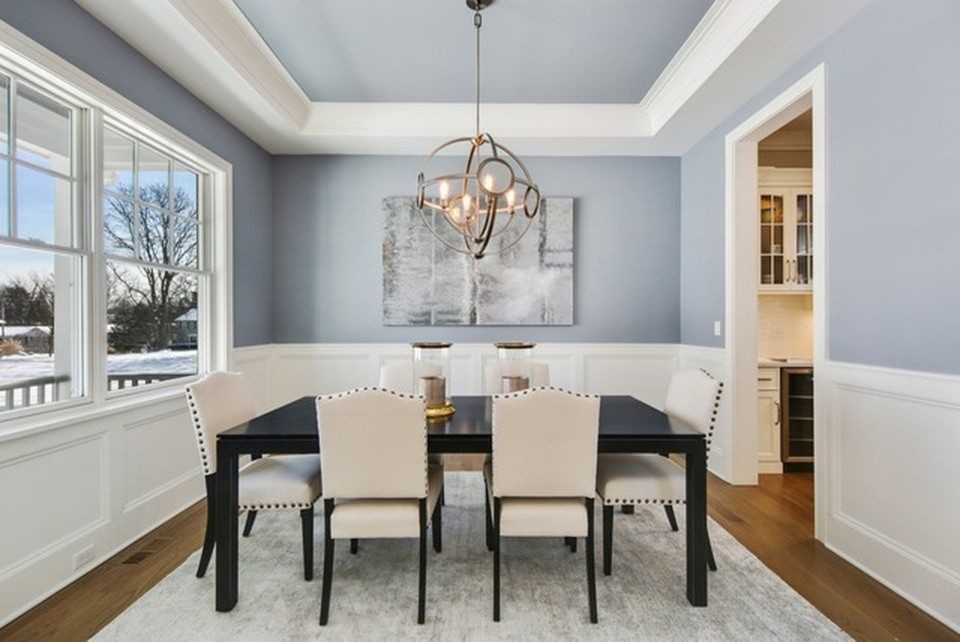This is an example of a medium sized classic enclosed dining room in Chicago with grey walls, medium hardwood flooring, no fireplace and brown floors.