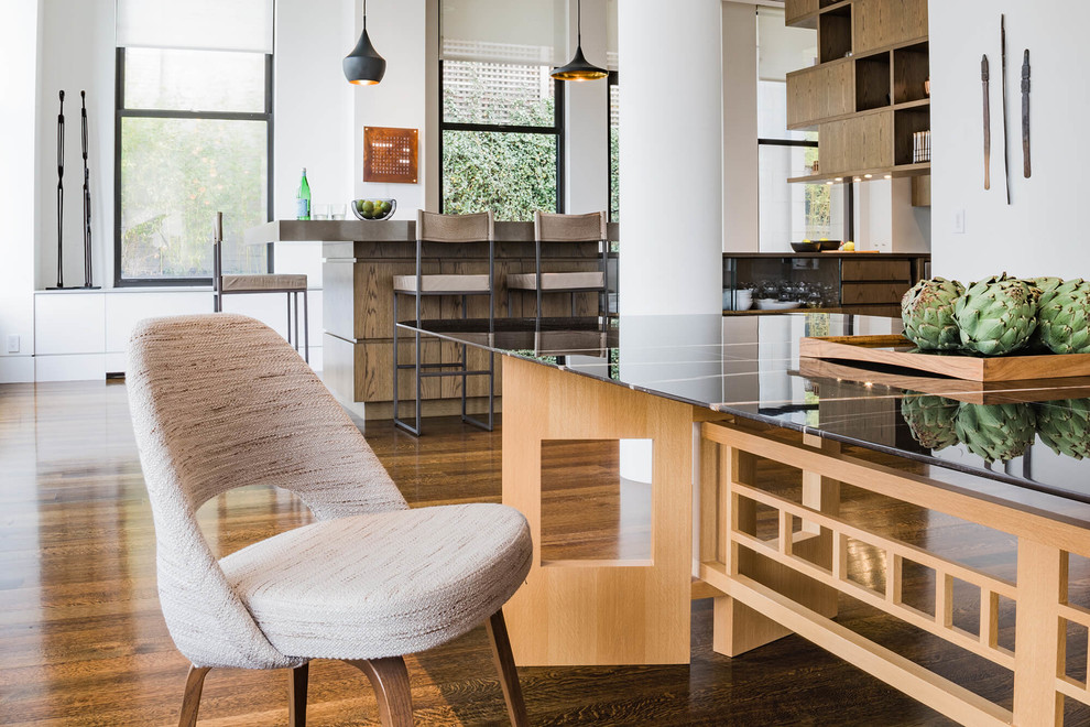 Inspiration pour une grande salle à manger ouverte sur le salon design avec un mur blanc, un sol en bois brun, une cheminée d'angle, un manteau de cheminée en métal et un sol marron.