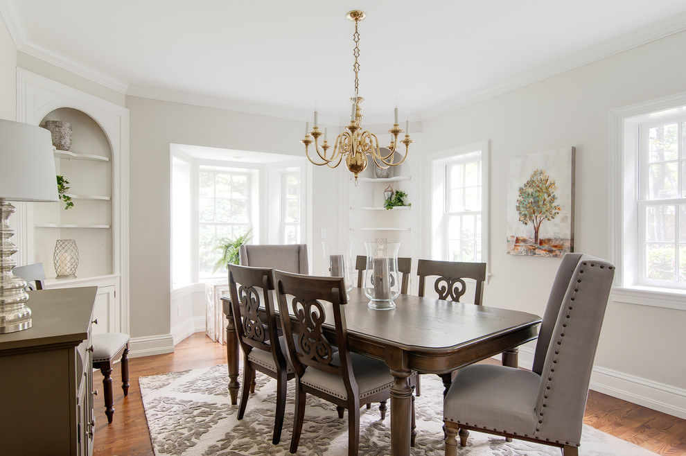Large traditional enclosed dining room in Boston with white walls, medium hardwood flooring and multi-coloured floors.