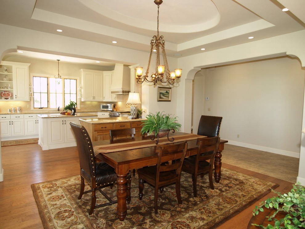 Example of a tuscan medium tone wood floor dining room design in Sacramento