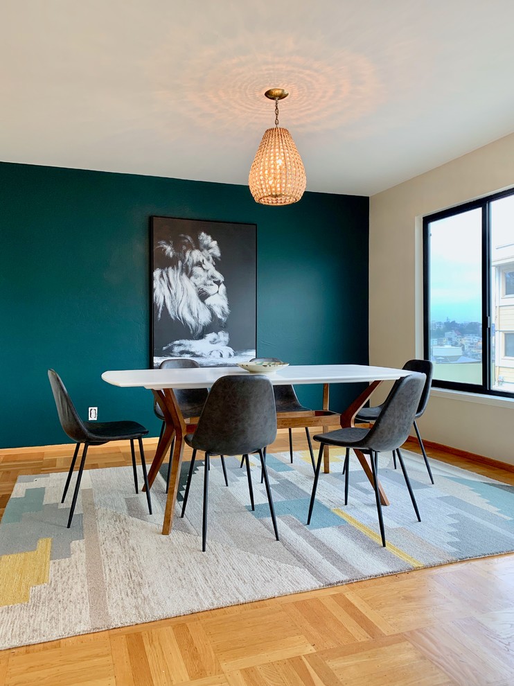Photo of a small midcentury enclosed dining room in San Francisco with blue walls, light hardwood flooring, no fireplace and brown floors.