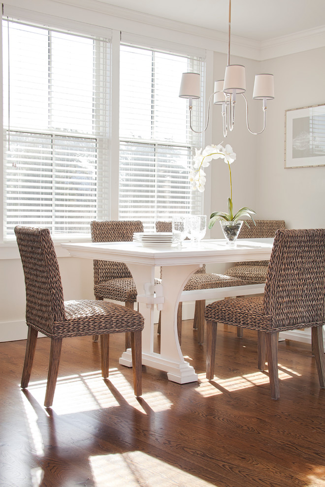 This is an example of a coastal dining room in Boston with beige walls, dark hardwood flooring and no fireplace.