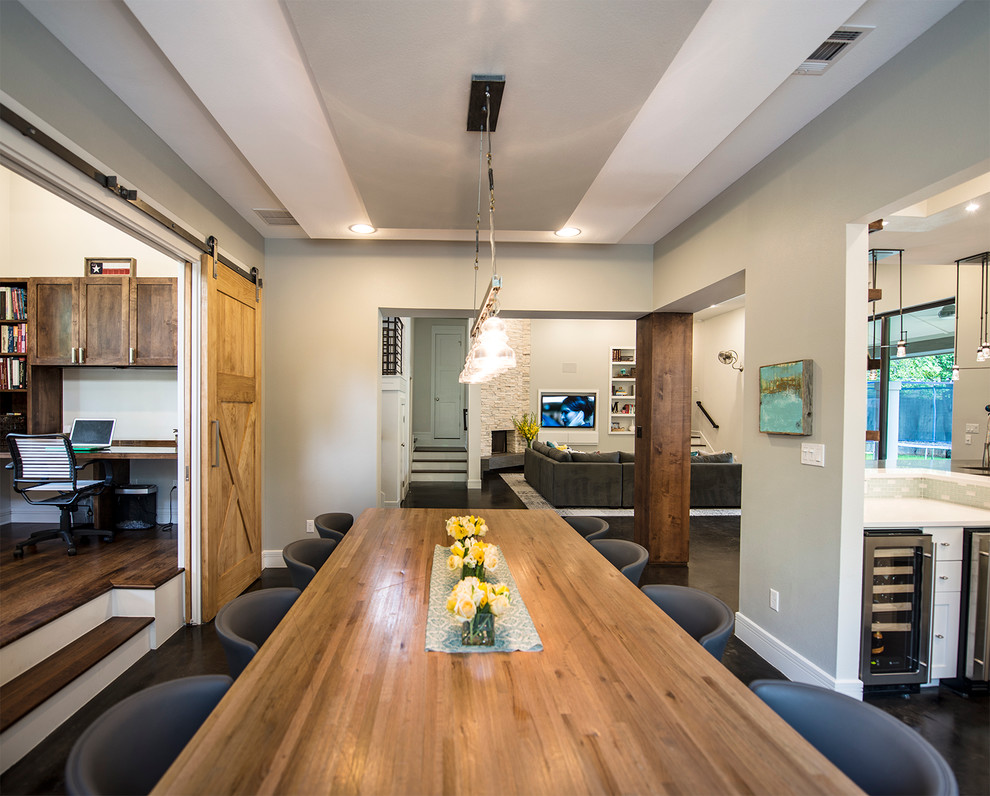 Example of a transitional concrete floor dining room design in Austin with white walls