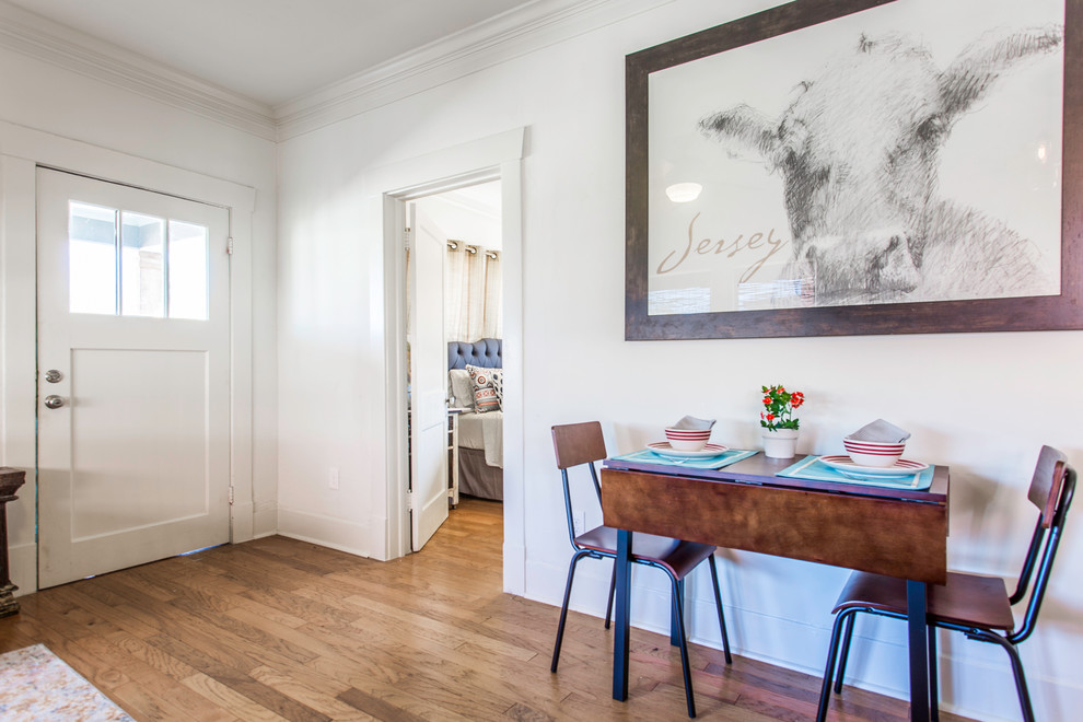 Idée de décoration pour une petite salle à manger tradition avec un mur blanc et parquet clair.