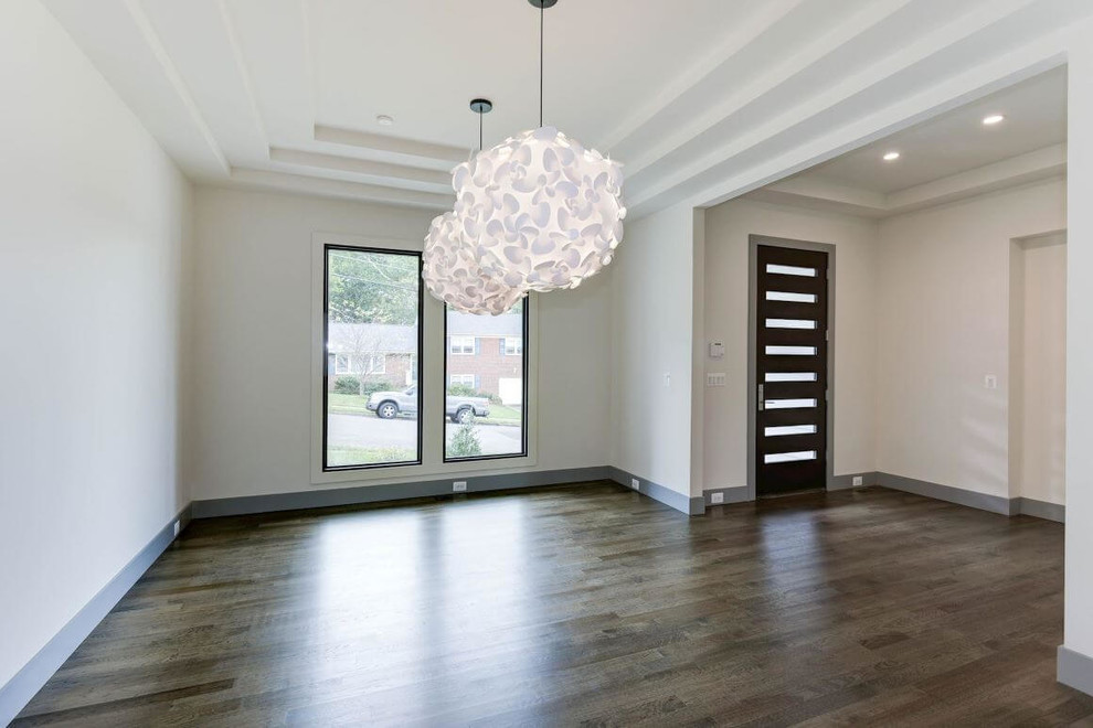 Large contemporary enclosed dining room in DC Metro with white walls, dark hardwood flooring and brown floors.