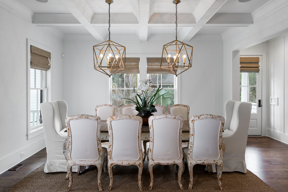 Example of a beach style dark wood floor dining room design in Charleston with white walls