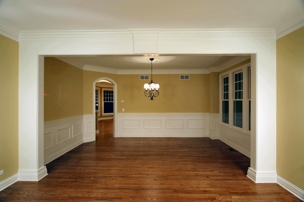 Large elegant medium tone wood floor great room photo in Chicago with yellow walls