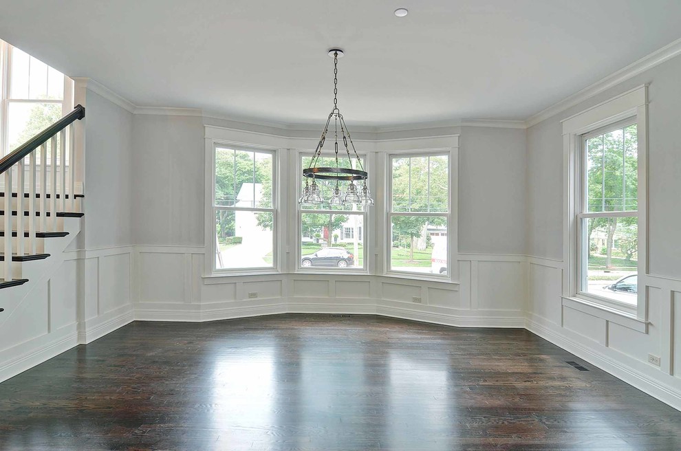 Photo of a large classic open plan dining room in Chicago with white walls and dark hardwood flooring.