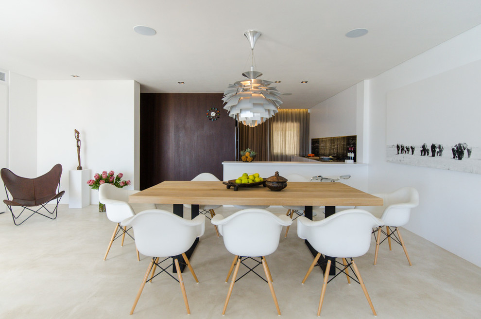 Example of a minimalist concrete floor dining room design in Other