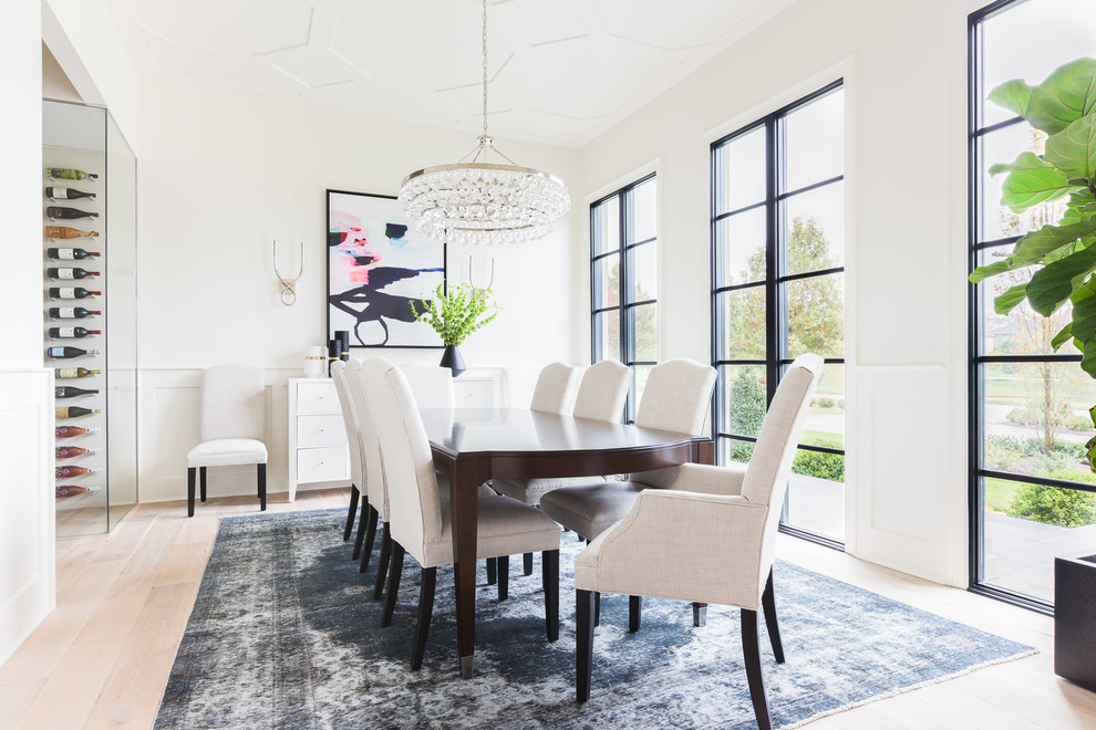 Photo of a classic dining room in Nashville with white walls and light hardwood flooring.
