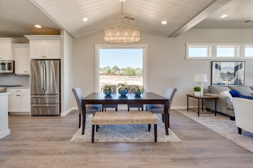 Kitchen/dining room combo - mid-sized transitional light wood floor and gray floor kitchen/dining room combo idea in Boise with gray walls and no fireplace