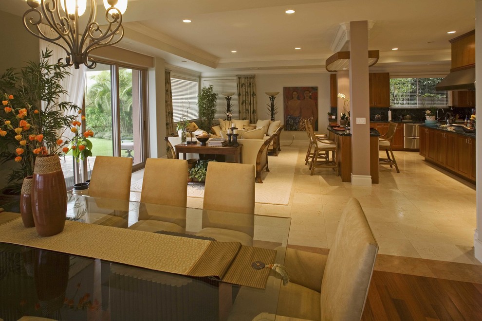 Example of a large island style medium tone wood floor and brown floor great room design in Hawaii with green walls and no fireplace