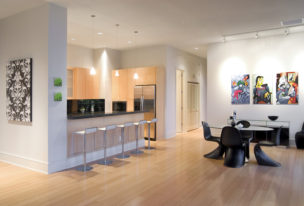 This is an example of a medium sized modern kitchen/dining room in Seattle with white walls, light hardwood flooring, no fireplace and feature lighting.