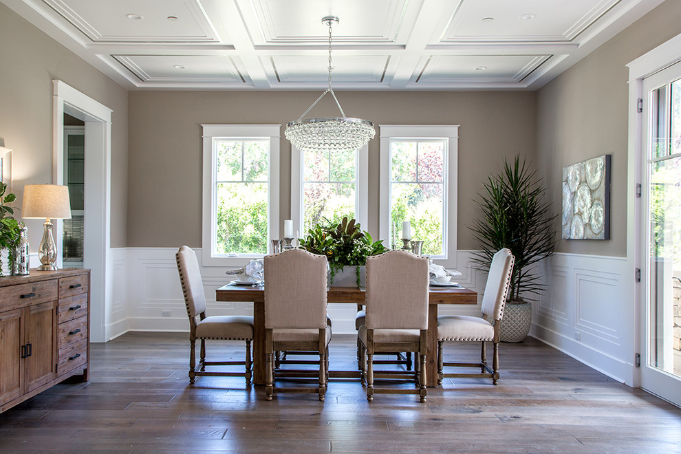 This is an example of a traditional enclosed dining room in Los Angeles with brown walls and dark hardwood flooring.