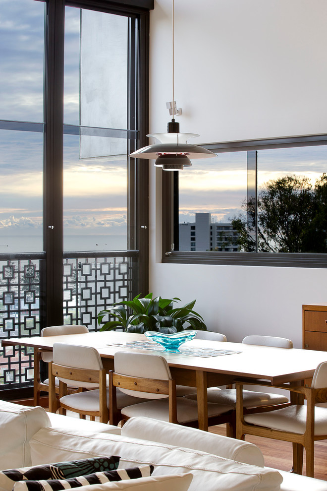 Photo of a modern open plan dining room in Gold Coast - Tweed with medium hardwood flooring.