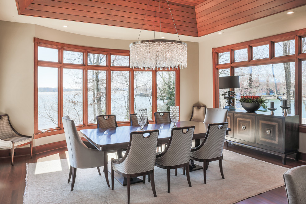 Example of a transitional dark wood floor dining room design in Charlotte with beige walls