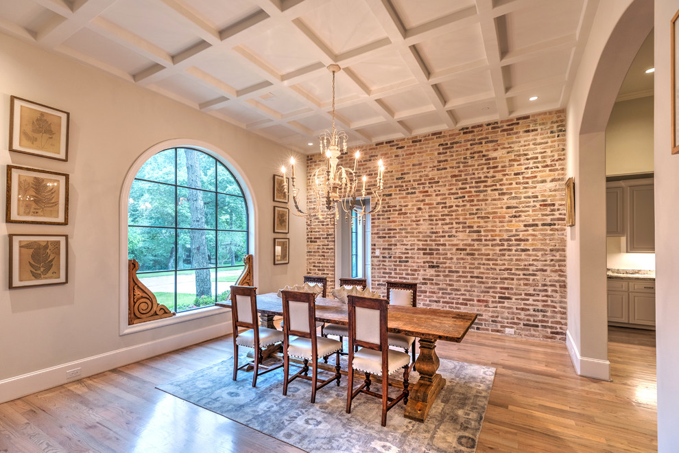 Inspiration for a traditional dining room in Houston with beige walls, light hardwood flooring and a feature wall.