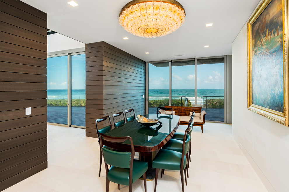 This is an example of a contemporary dining room in Miami with white walls and white floors.