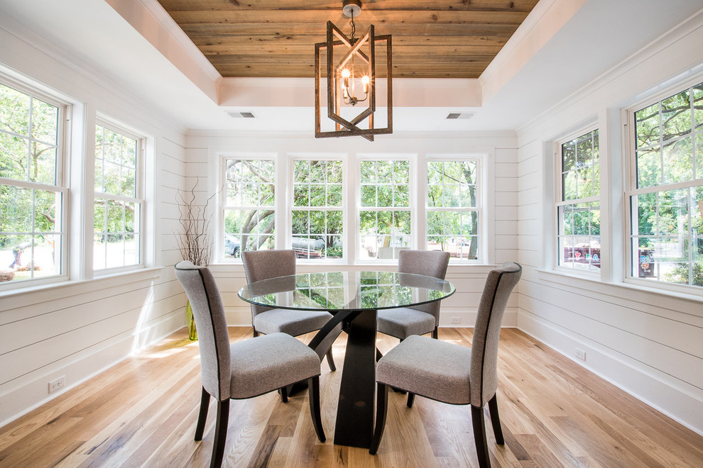 Photo of a medium sized traditional kitchen/dining room in Charleston with white walls, light hardwood flooring and no fireplace.