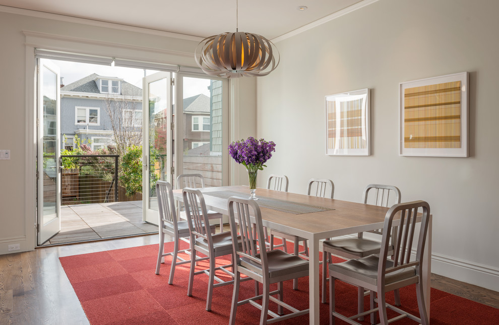 Example of a trendy concrete floor dining room design in San Francisco with white walls