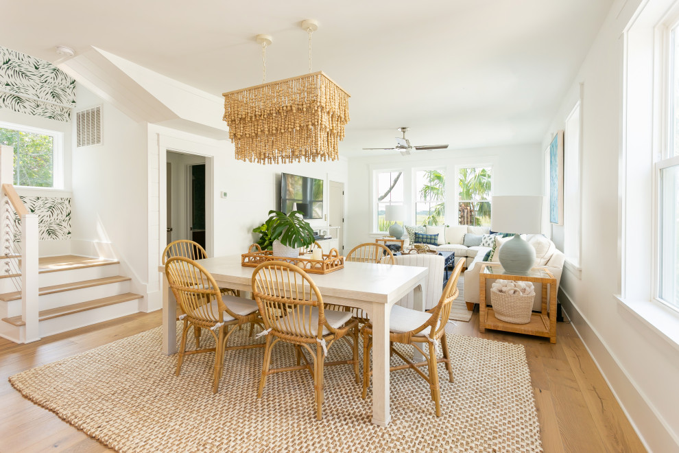 Inspiration for a mid-sized tropical light wood floor dining room remodel in Charleston with white walls