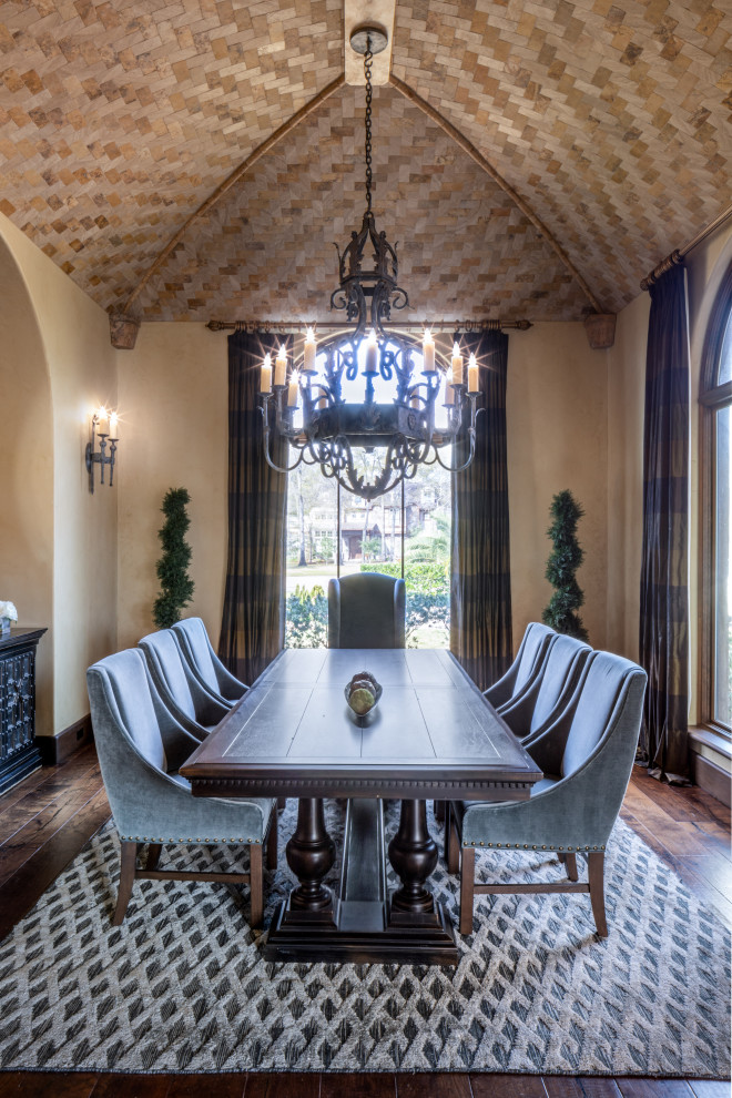 This is an example of a large classic kitchen/dining room in Houston with beige walls, dark hardwood flooring, no fireplace, brown floors and a vaulted ceiling.