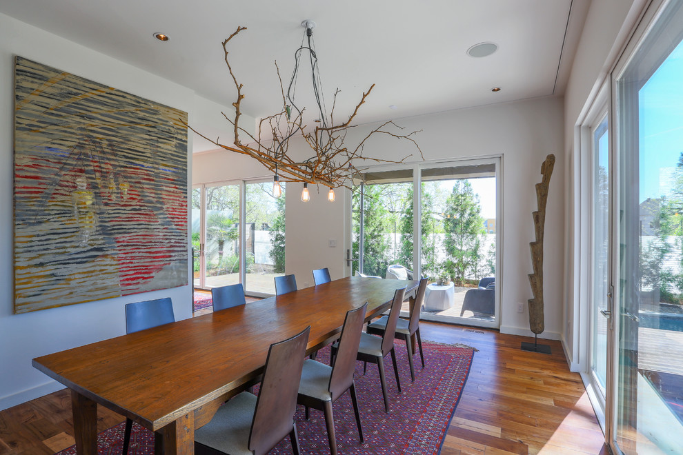 Mid-sized trendy medium tone wood floor dining room photo in Atlanta with white walls and no fireplace
