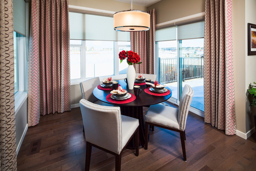 Photo of a contemporary dining room in Calgary with beige walls and dark hardwood flooring.