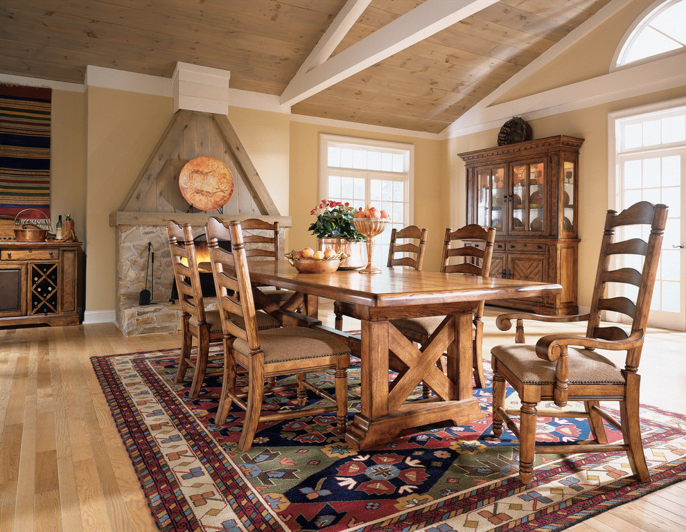 Enclosed dining room - large french country light wood floor and beige floor enclosed dining room idea in San Francisco with beige walls, a standard fireplace and a stone fireplace