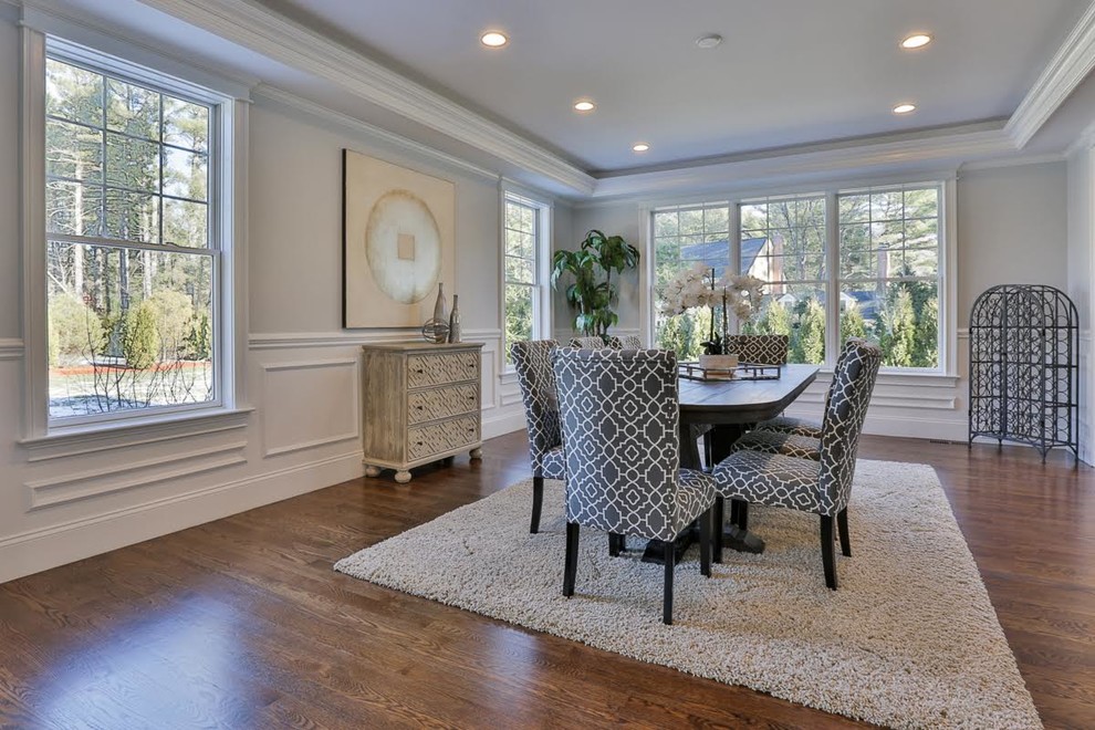 Large classic enclosed dining room in Boston with grey walls, medium hardwood flooring, no fireplace and brown floors.