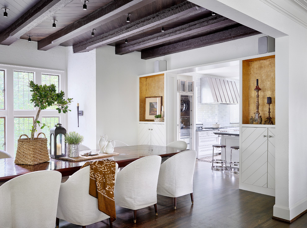 This is an example of a rural dining room in Chicago with white walls and dark hardwood flooring.