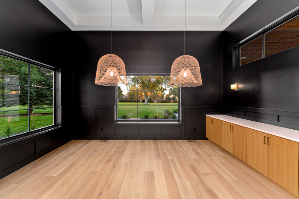 Inspiration for a modern light wood floor dining room remodel in Denver with black walls