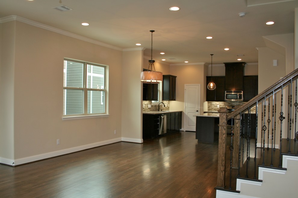 Mid-sized elegant medium tone wood floor kitchen/dining room combo photo in Houston with beige walls and no fireplace