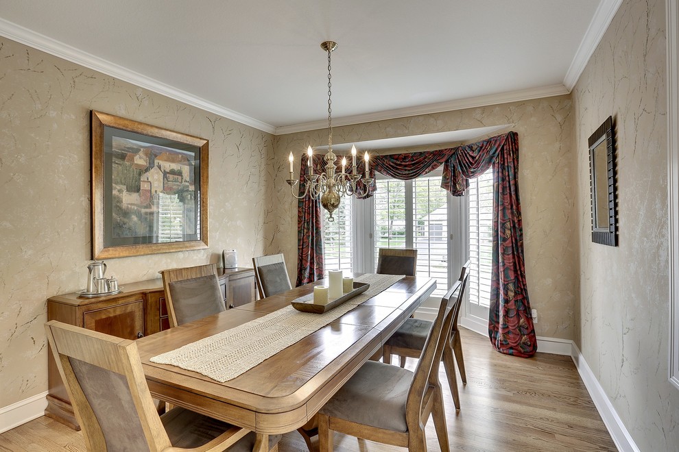 Photo of a medium sized classic enclosed dining room in Minneapolis with brown walls, medium hardwood flooring and no fireplace.